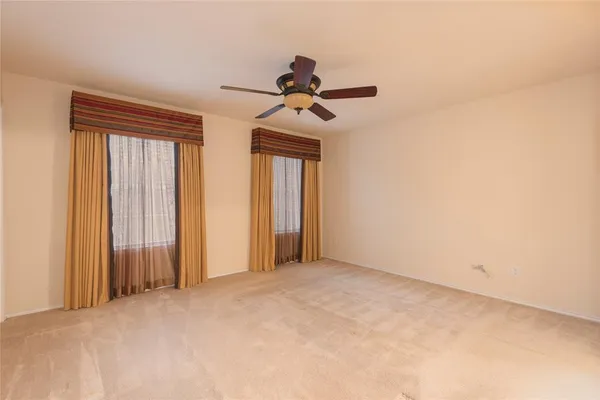 a view of a room with a ceiling fan