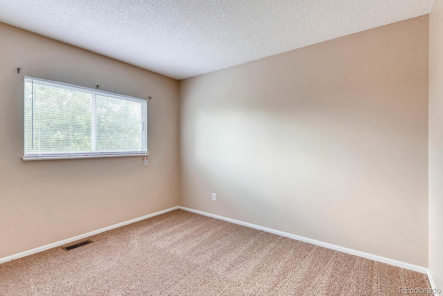 2874 South Genoa Street Aurora, CO 80013 - Photo 11 of 22 an empty room with a window