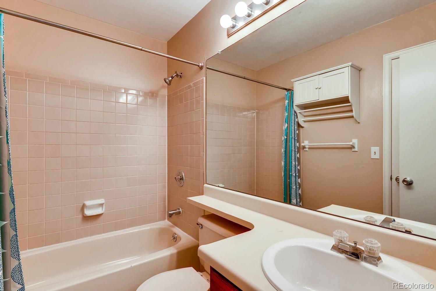 2874 South Genoa Street Aurora, CO 80013 - Photo 13 of 22 a bathroom with a sink and a bathtub