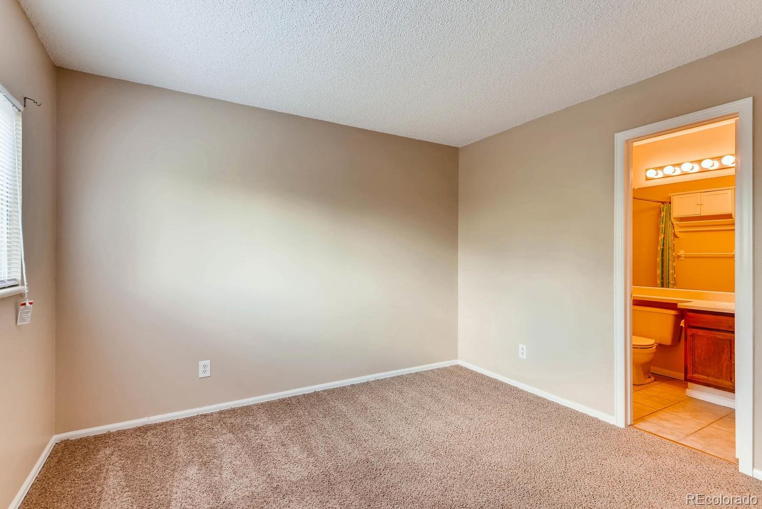 2874 South Genoa Street Aurora, CO 80013 - Photo 15 of 22 an empty room with a window