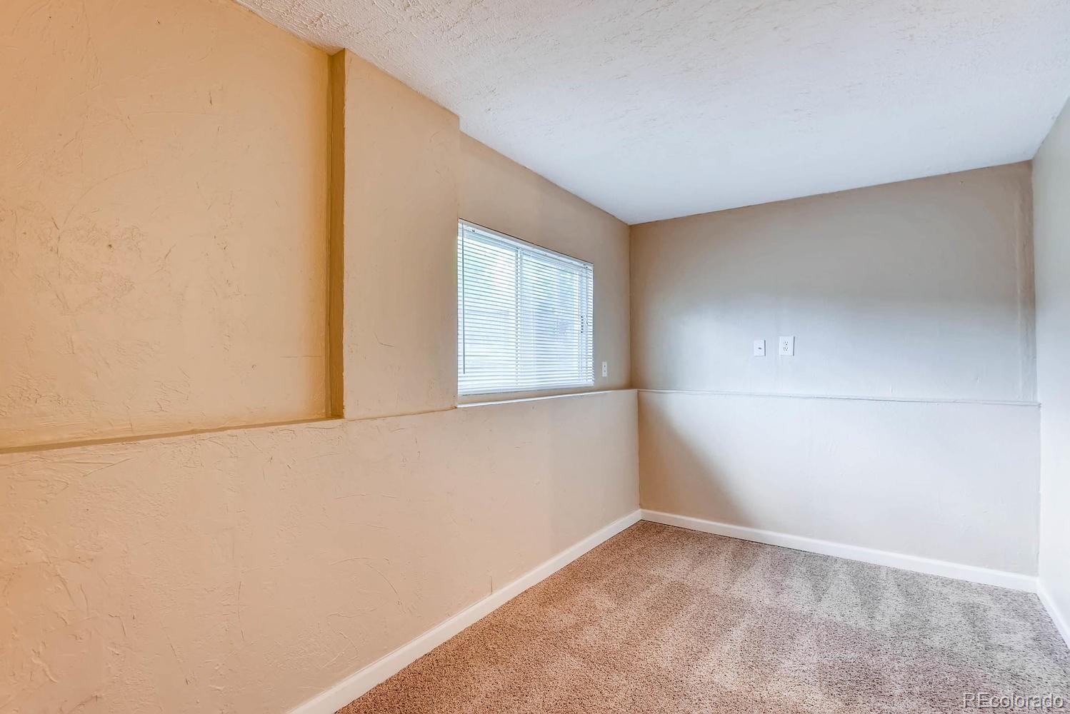 2874 South Genoa Street Aurora, CO 80013 - Photo 17 of 22 a view of an empty room with a window