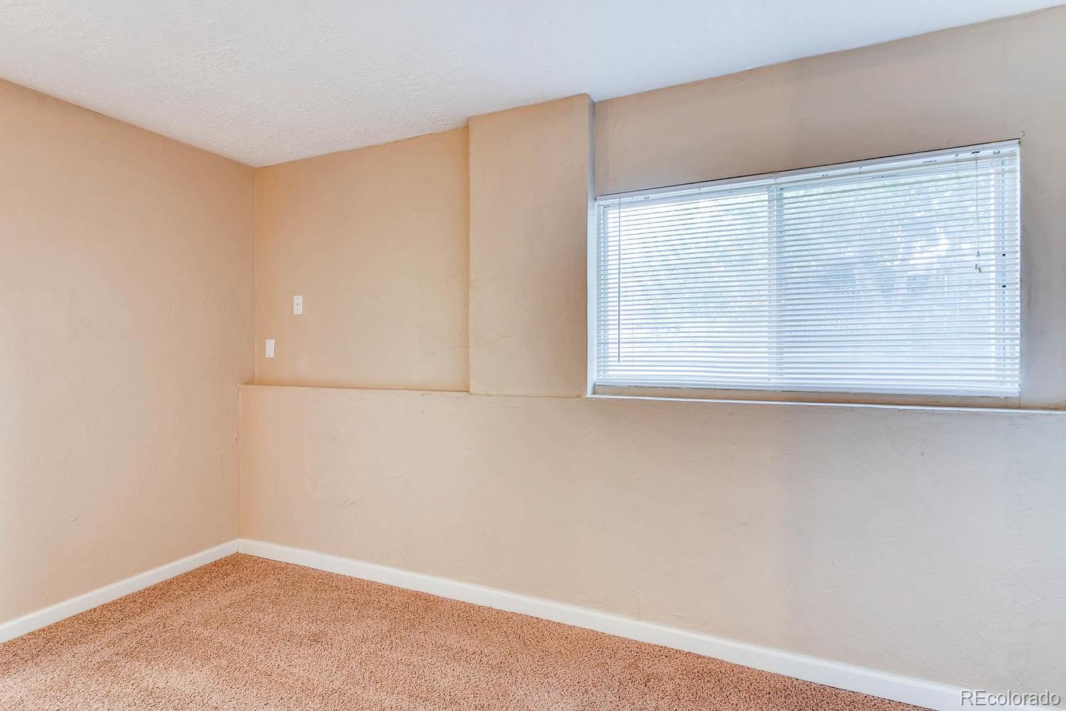 2874 South Genoa Street Aurora, CO 80013 - Photo 18 of 22 an empty room with a window