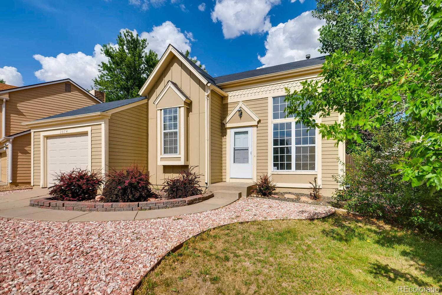 2874 South Genoa Street Aurora, CO 80013 - Photo 2 of 22 a front view of a house with garden
