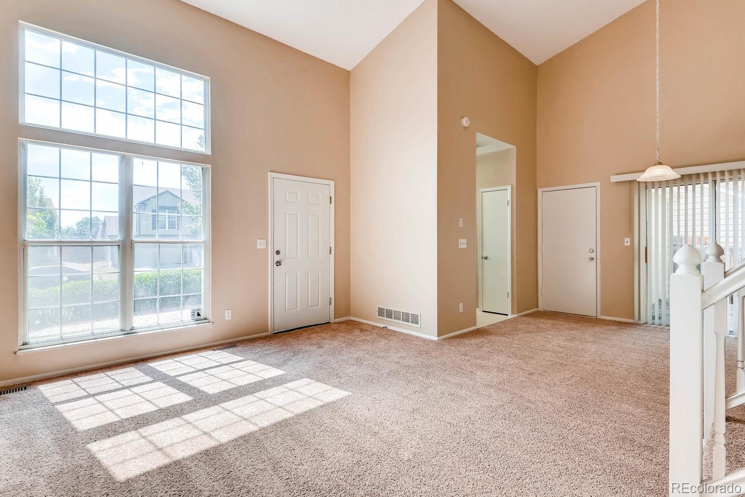 2874 South Genoa Street Aurora, CO 80013 - Photo 4 of 22 an empty room with windows and closet