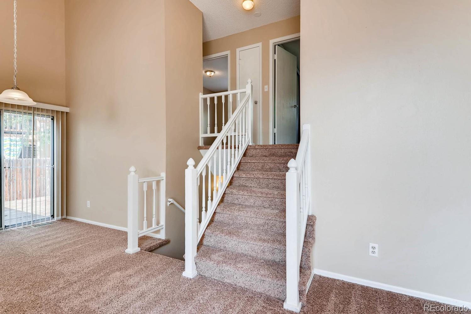 2874 South Genoa Street Aurora, CO 80013 - Photo 6 of 22 a view of a hallway with wooden floor and entryway
