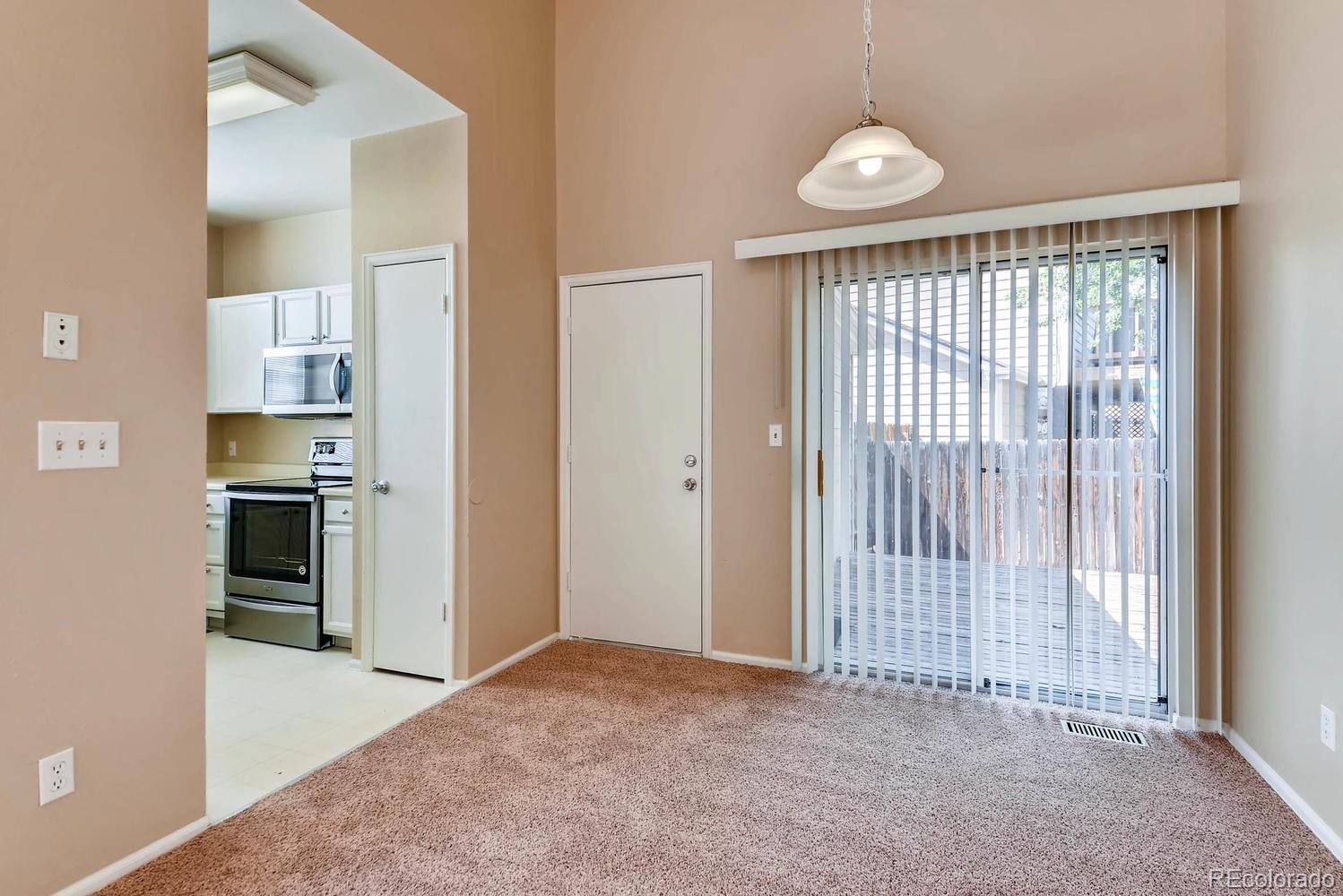 2874 South Genoa Street Aurora, CO 80013 - Photo 7 of 22 a view of a kitchen with a refrigerator a sink and dishwasher