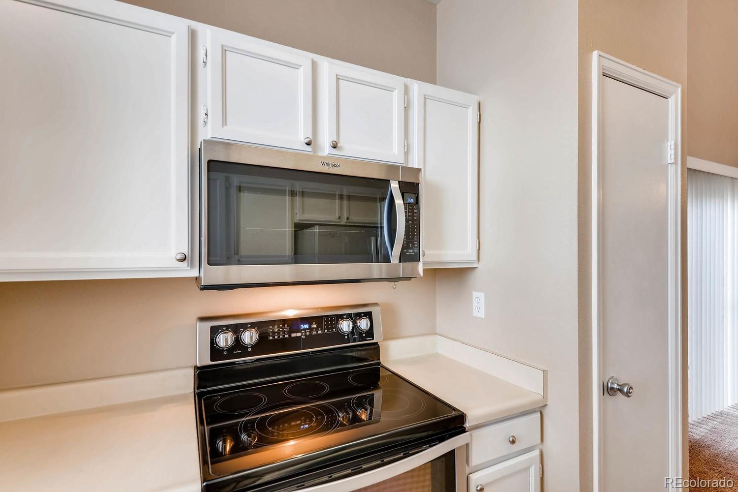 2874 South Genoa Street Aurora, CO 80013 - Photo 9 of 22 a kitchen with wooden cabinets and a stove top oven