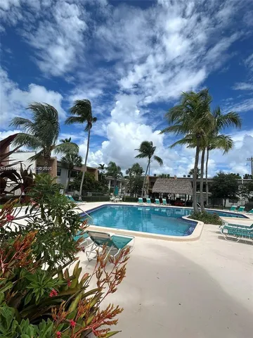 a view of a yard with swimming pool