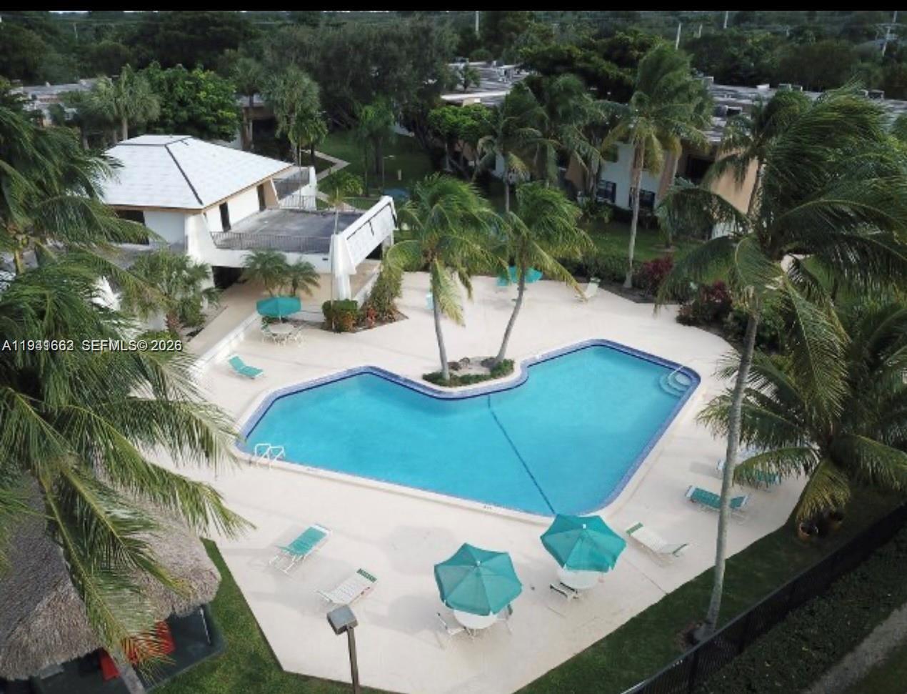 8261 Southwest 128th Street, Unit 202 Pinecrest, FL 33156 - Photo 3 of 6 a view of a house with a yard and sitting area