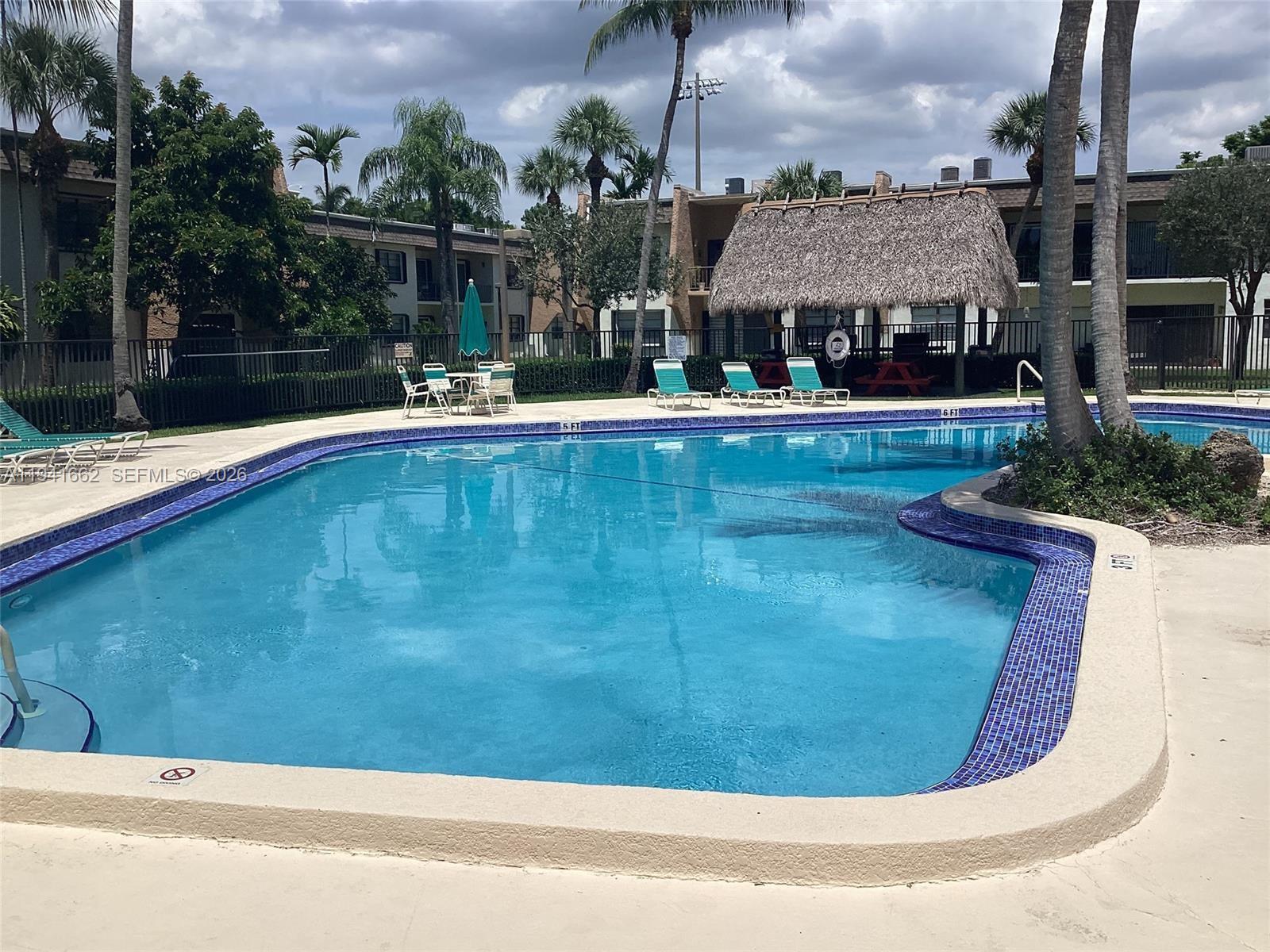 8261 Southwest 128th Street, Unit 202 Pinecrest, FL 33156 - Photo 6 of 6 a view of a swimming pool with a patio