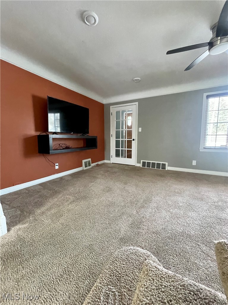 1544 Edgefield Road Lyndhurst, OH 44124 - Photo 12 of 36 Unfurnished living room featuring carpet and ceiling fan