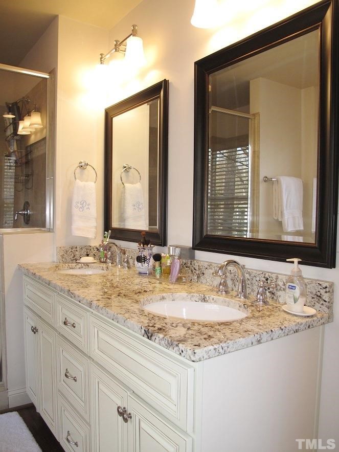 2405 Tyson Street Raleigh, NC 27612 - Photo 11 of 24 a bathroom with a granite countertop sink and a mirror