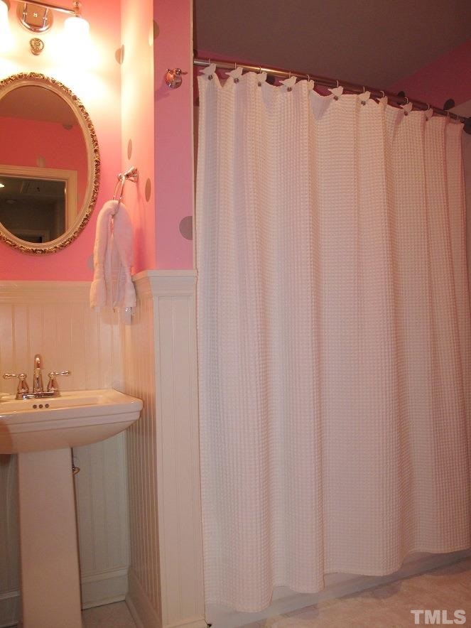 2405 Tyson Street Raleigh, NC 27612 - Photo 15 of 24 a bathroom with a sink and a mirror
