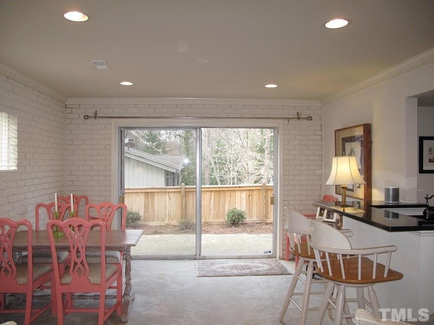 2405 Tyson Street Raleigh, NC 27612 - Photo 17 of 24 a living room with furniture a flat screen tv and a large window