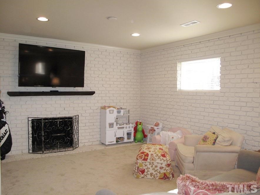 2405 Tyson Street Raleigh, NC 27612 - Photo 19 of 24 a bedroom with a bed and a flat screen tv