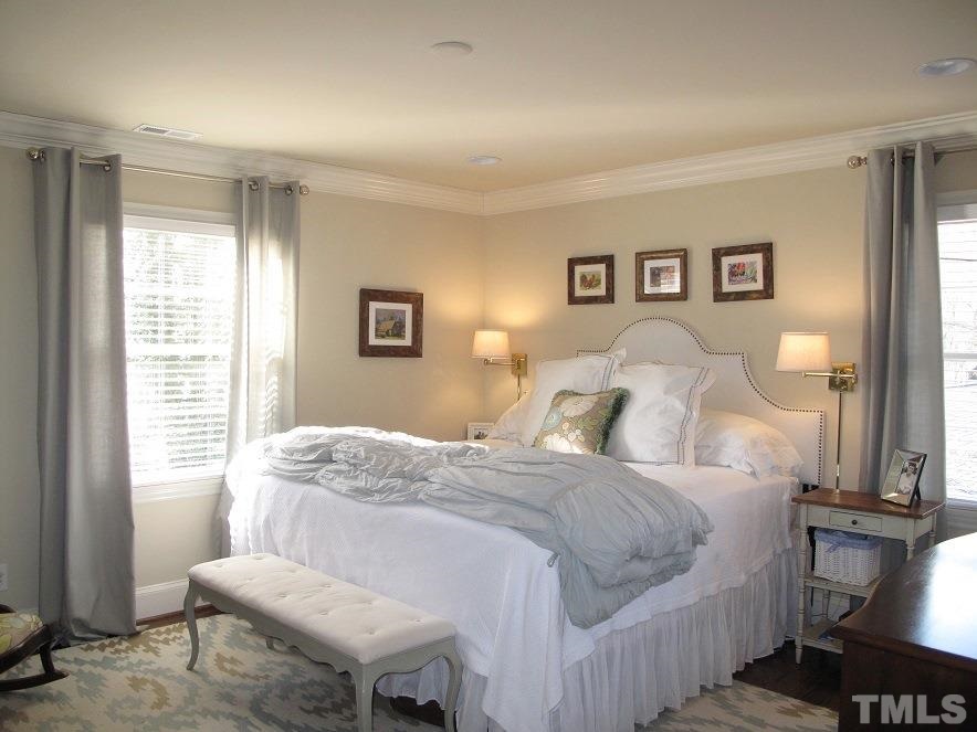 2405 Tyson Street Raleigh, NC 27612 - Photo 10 of 24 a bedroom with a bed and wooden floor