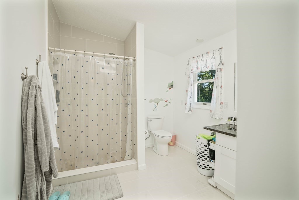 55 Gates Road Saugus, MA 01906 - Photo 16 of 42 a bathroom with a shower toilet and a sink