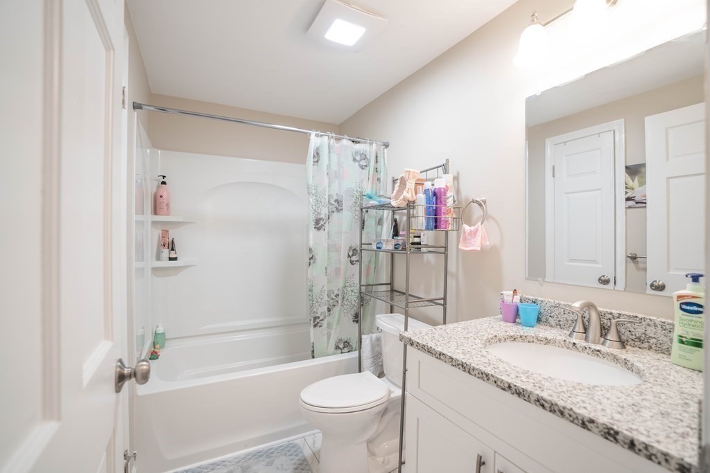 55 Gates Road Saugus, MA 01906 - Photo 20 of 42 a bathroom with a granite countertop sink toilet mirror and shower