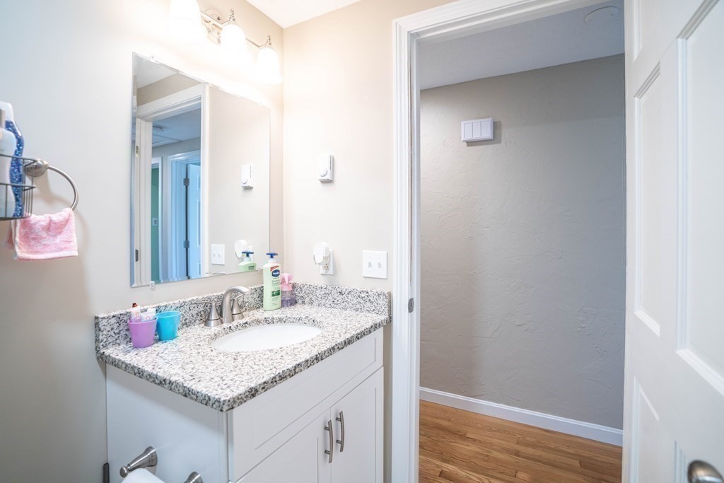 55 Gates Road Saugus, MA 01906 - Photo 21 of 42 a bathroom with a granite countertop sink and a mirror