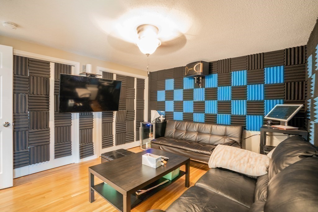 55 Gates Road Saugus, MA 01906 - Photo 25 of 42 a living room with furniture and a flat screen tv