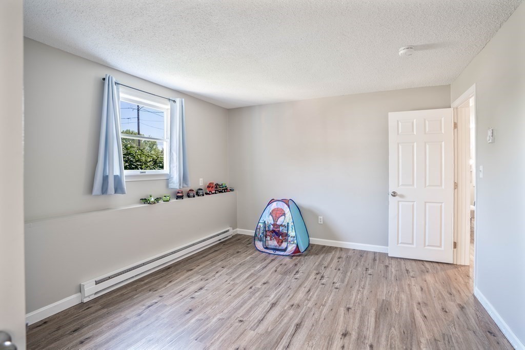 55 Gates Road Saugus, MA 01906 - Photo 33 of 42 an empty room with wooden floor and windows