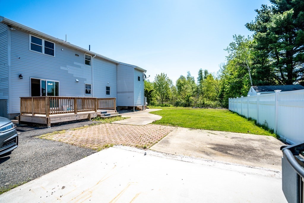 55 Gates Road Saugus, MA 01906 - Photo 35 of 42 a view of a backyard with a tub and trees in the background