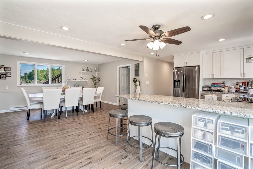 55 Gates Road Saugus, MA 01906 - Photo 4 of 42 a large kitchen with a dining table chairs stainless steel appliances and cabinets