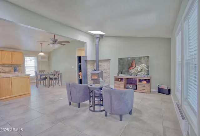 a living room with furniture and kitchen view