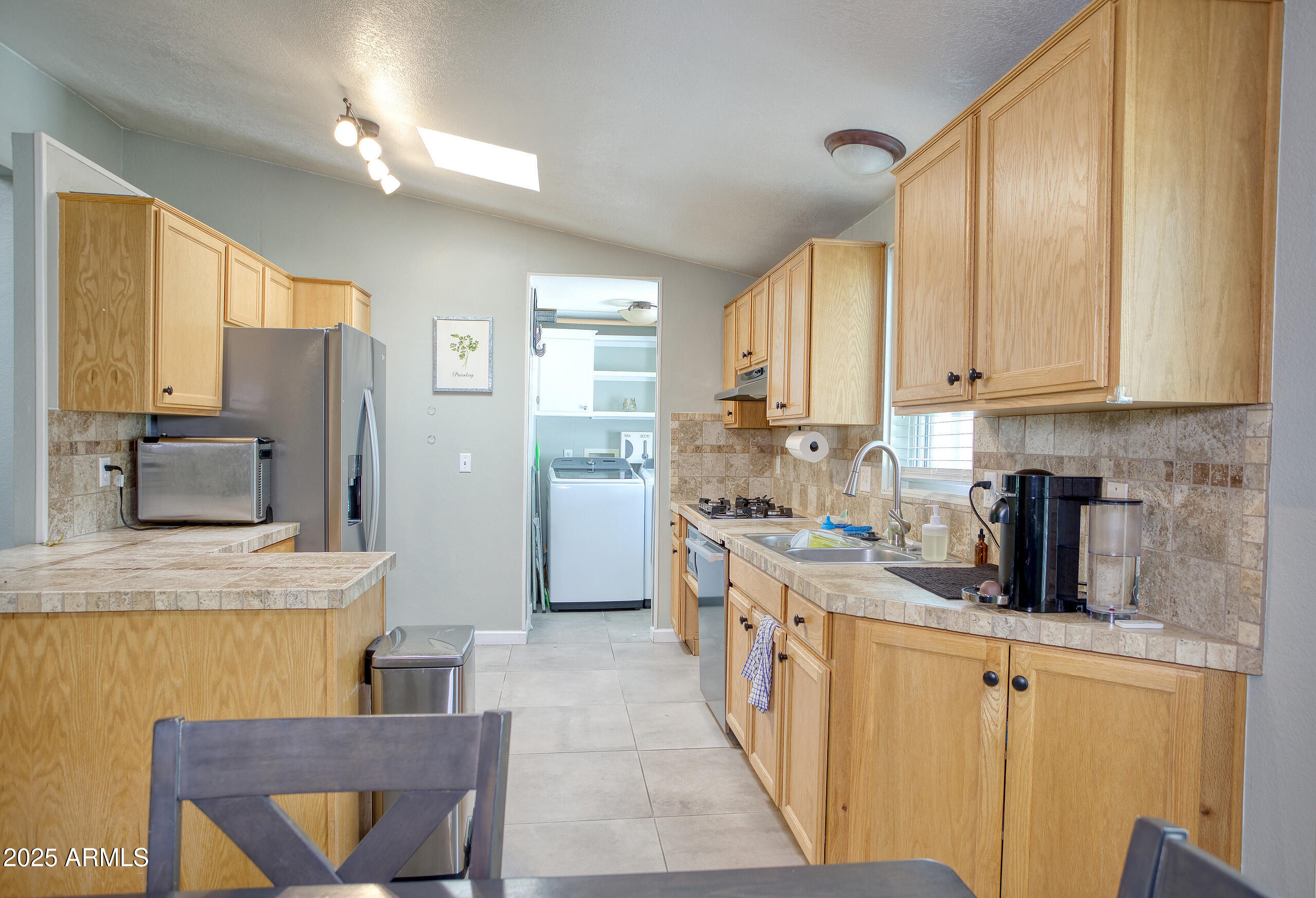 17090 Iron Springs Road Munds Park, AZ 86017 - Photo 15 of 68 a kitchen with stainless steel appliances granite countertop a sink stove and refrigerator