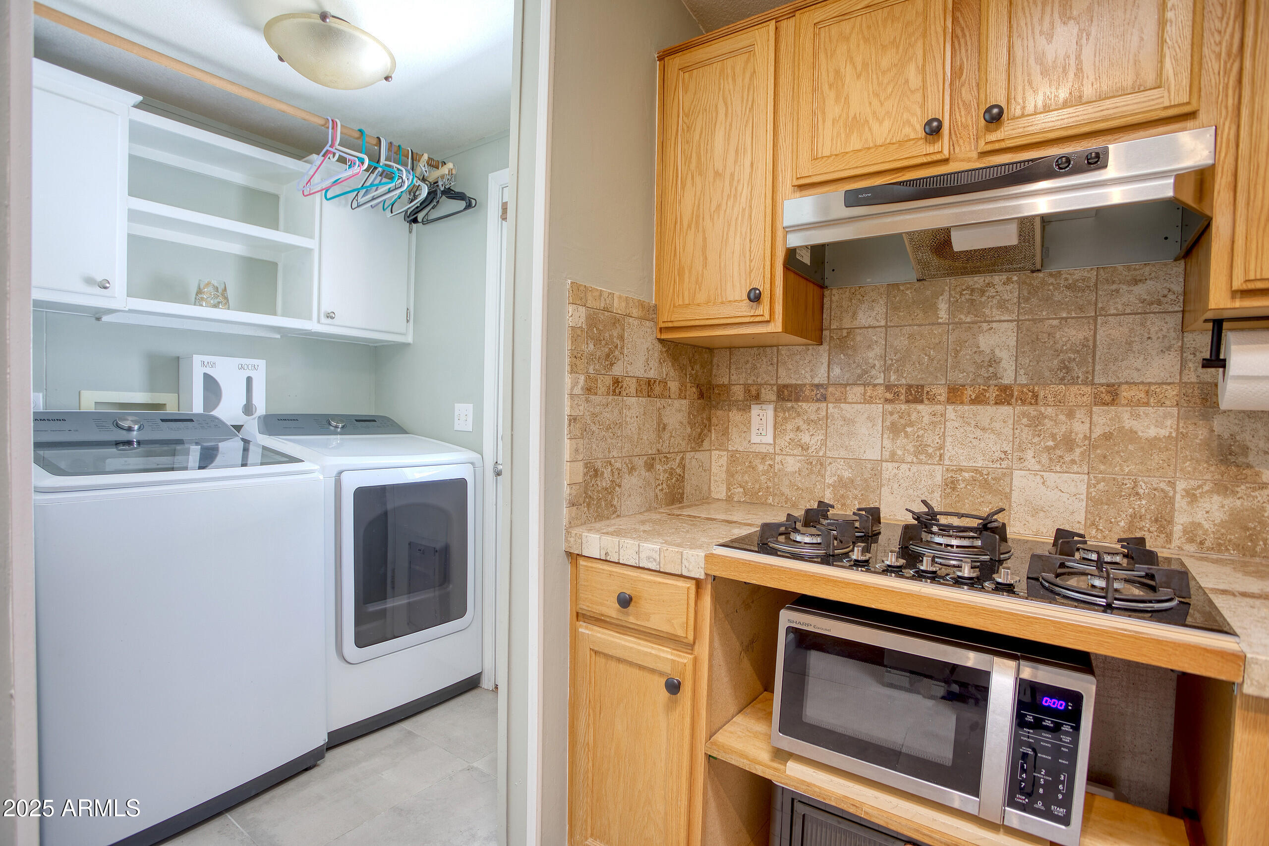 17090 Iron Springs Road Munds Park, AZ 86017 - Photo 20 of 68 a kitchen with stainless steel appliances granite countertop a stove and a microwave