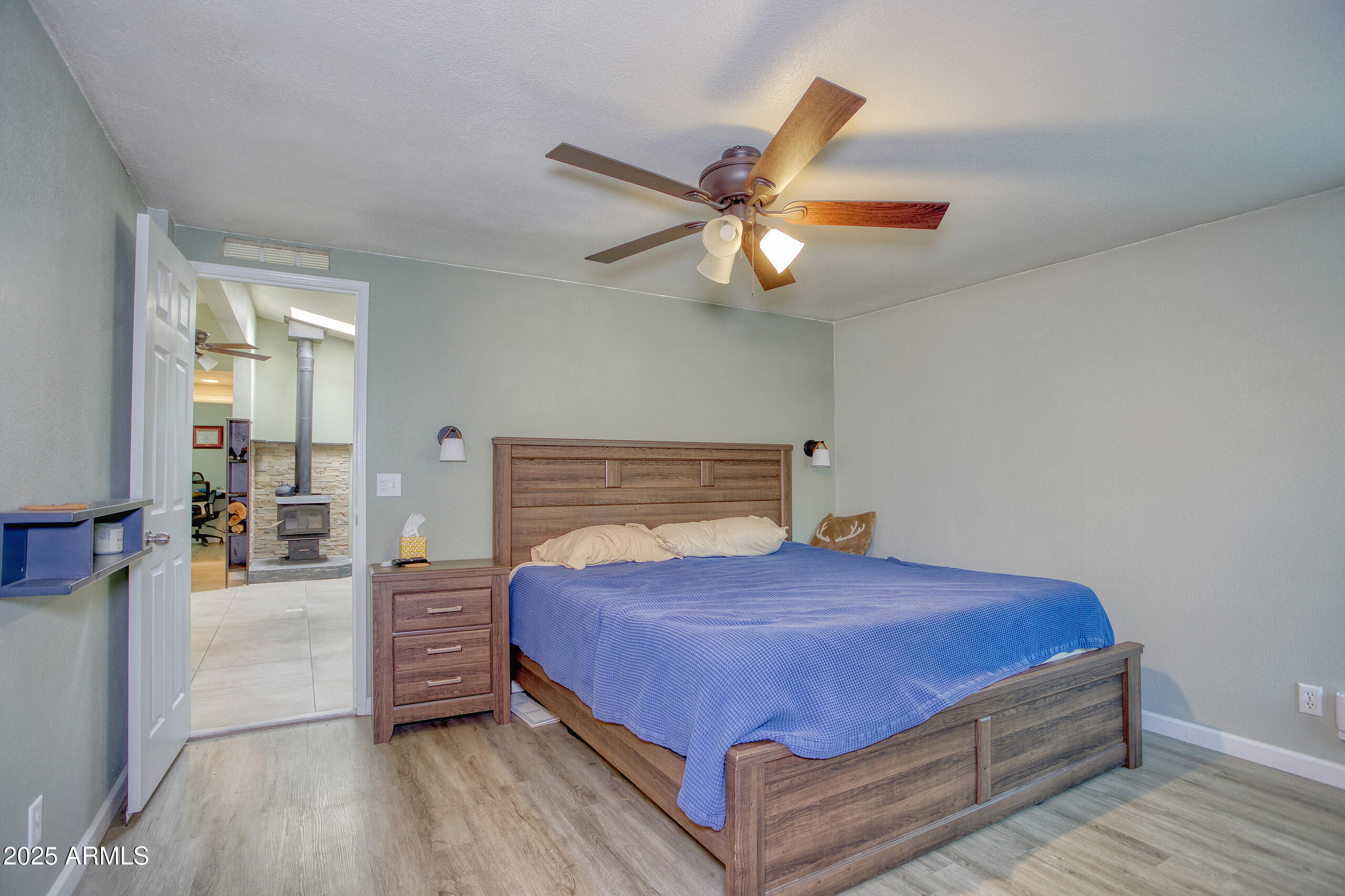 17090 Iron Springs Road Munds Park, AZ 86017 - Photo 26 of 68 a bedroom with a bed and a chandelier