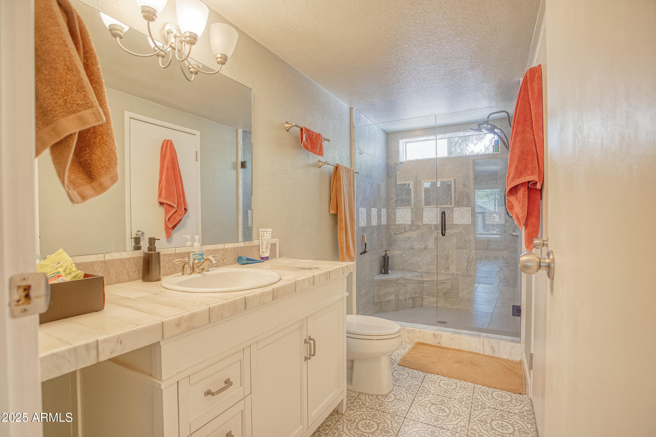 17090 Iron Springs Road Munds Park, AZ 86017 - Photo 29 of 68 a bathroom with a double vanity sink toilet mirror and shower