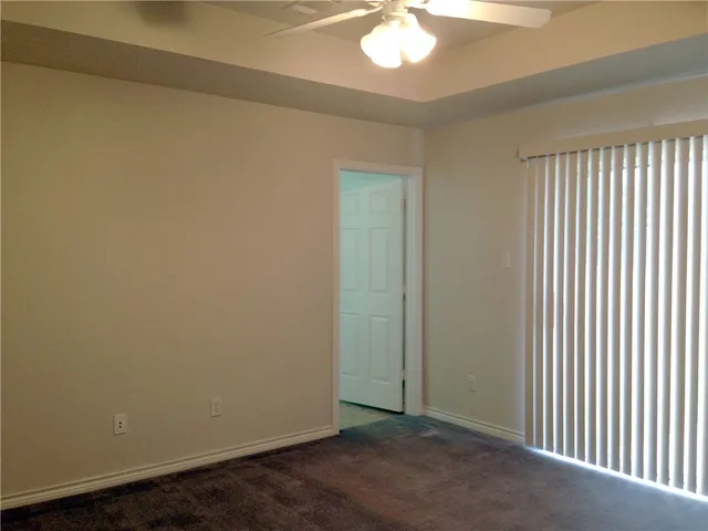 an empty room with closet and wooden floor