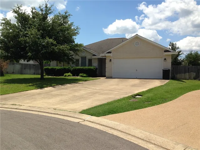 a house that has a tree in front of it