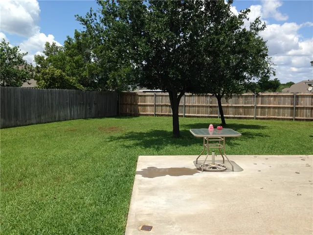 a view of a backyard with sitting area