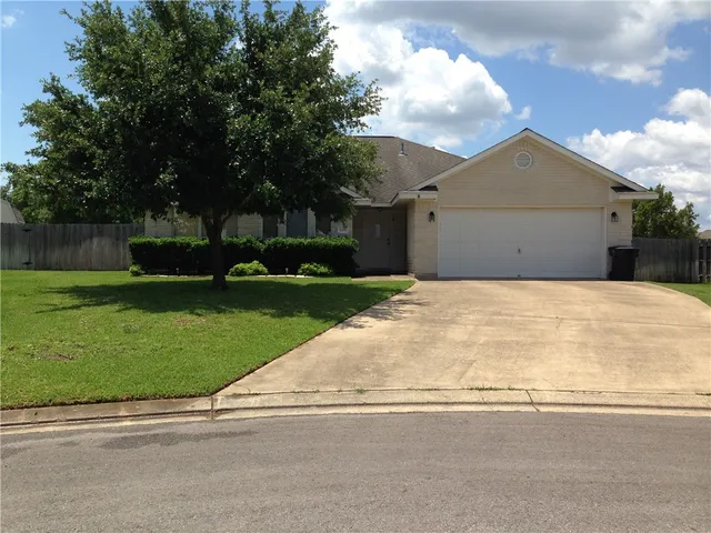 a view of backyard of house and trees