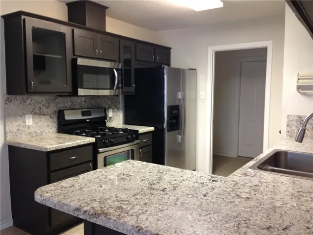 a kitchen with a stove and a refrigerator