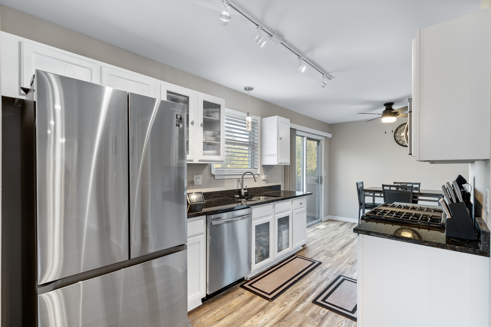 413 Ballard Drive Algonquin, IL 60102 - Photo 6 of 35 a kitchen with stainless steel appliances a refrigerator stove and sink