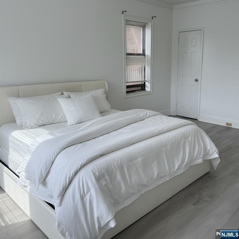 100 Prospect Avenue, Unit 2E Hackensack, NJ 07601 - Photo 13 of 16 a large white bed in a white room