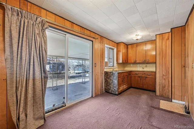 a large kitchen with a large window and stainless steel appliances