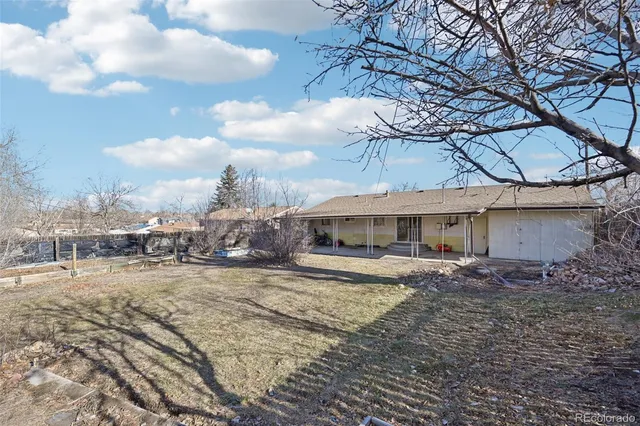 a view of a house with a yard and sitting area