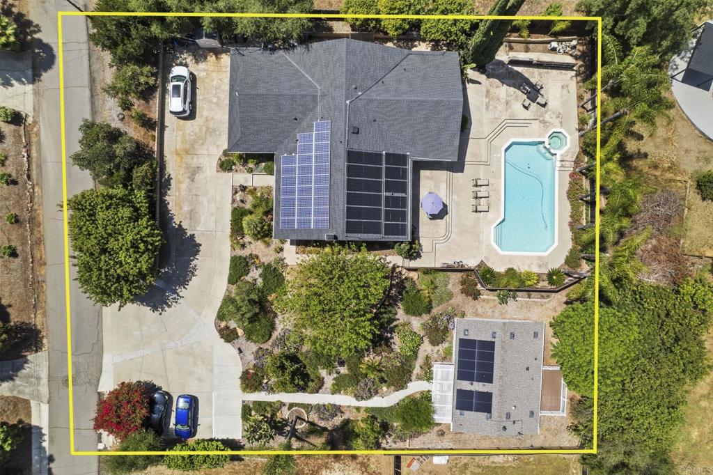 an aerial view of a house with a swimming pool