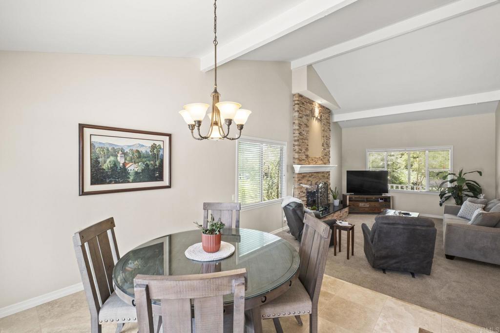 1973 Felicita Road Escondido, CA 92025 - Photo 12 of 55 a view of a dining room with furniture a fireplace and large windows