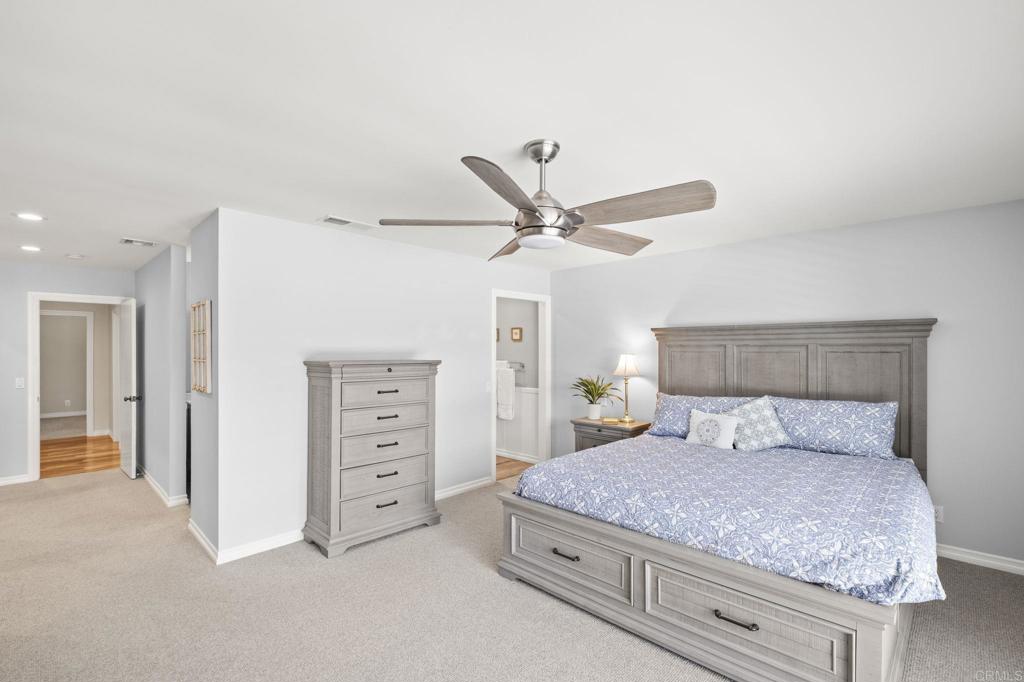 1973 Felicita Road Escondido, CA 92025 - Photo 24 of 55 a bedroom with a bed and a ceiling fan