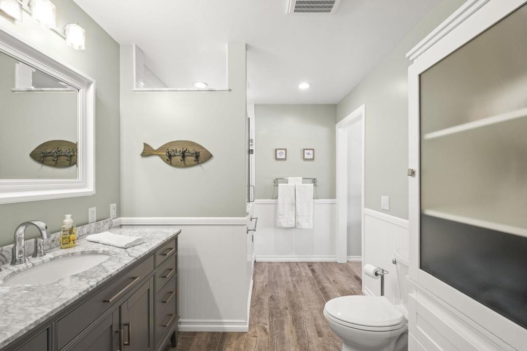 1973 Felicita Road Escondido, CA 92025 - Photo 26 of 55 a bathroom with a granite countertop sink a toilet and a large mirror