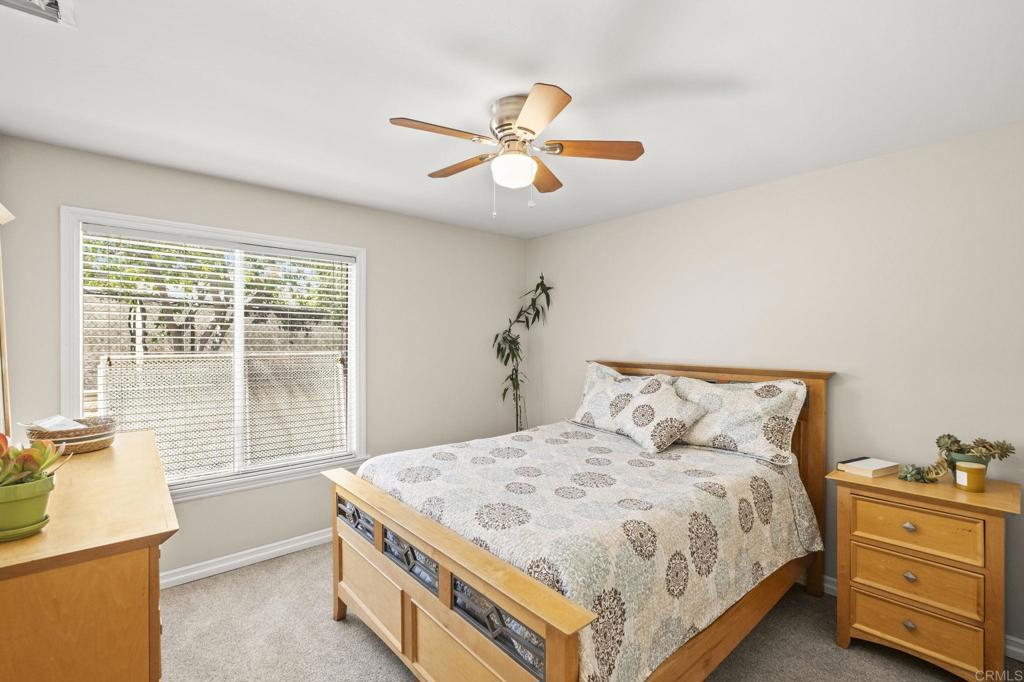 1973 Felicita Road Escondido, CA 92025 - Photo 29 of 55 a bedroom with a bed and a chandelier