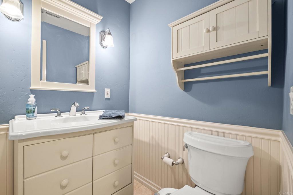 1973 Felicita Road Escondido, CA 92025 - Photo 33 of 55 a bathroom with a sink a toilet and mirror