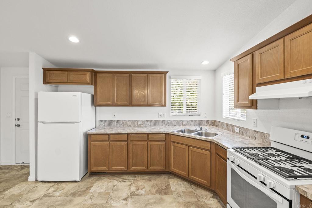 1973 Felicita Road Escondido, CA 92025 - Photo 47 of 55 a kitchen with a sink stove and refrigerator