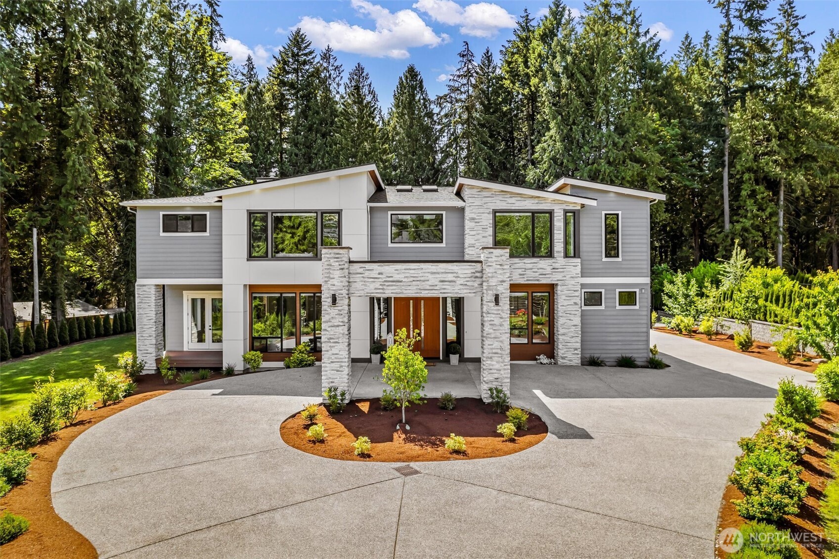 a front view of a house with a yard fire pit and outdoor seating