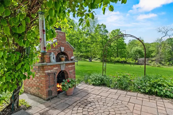 a view of a patio with table and chairs and potted plants with wooden fence